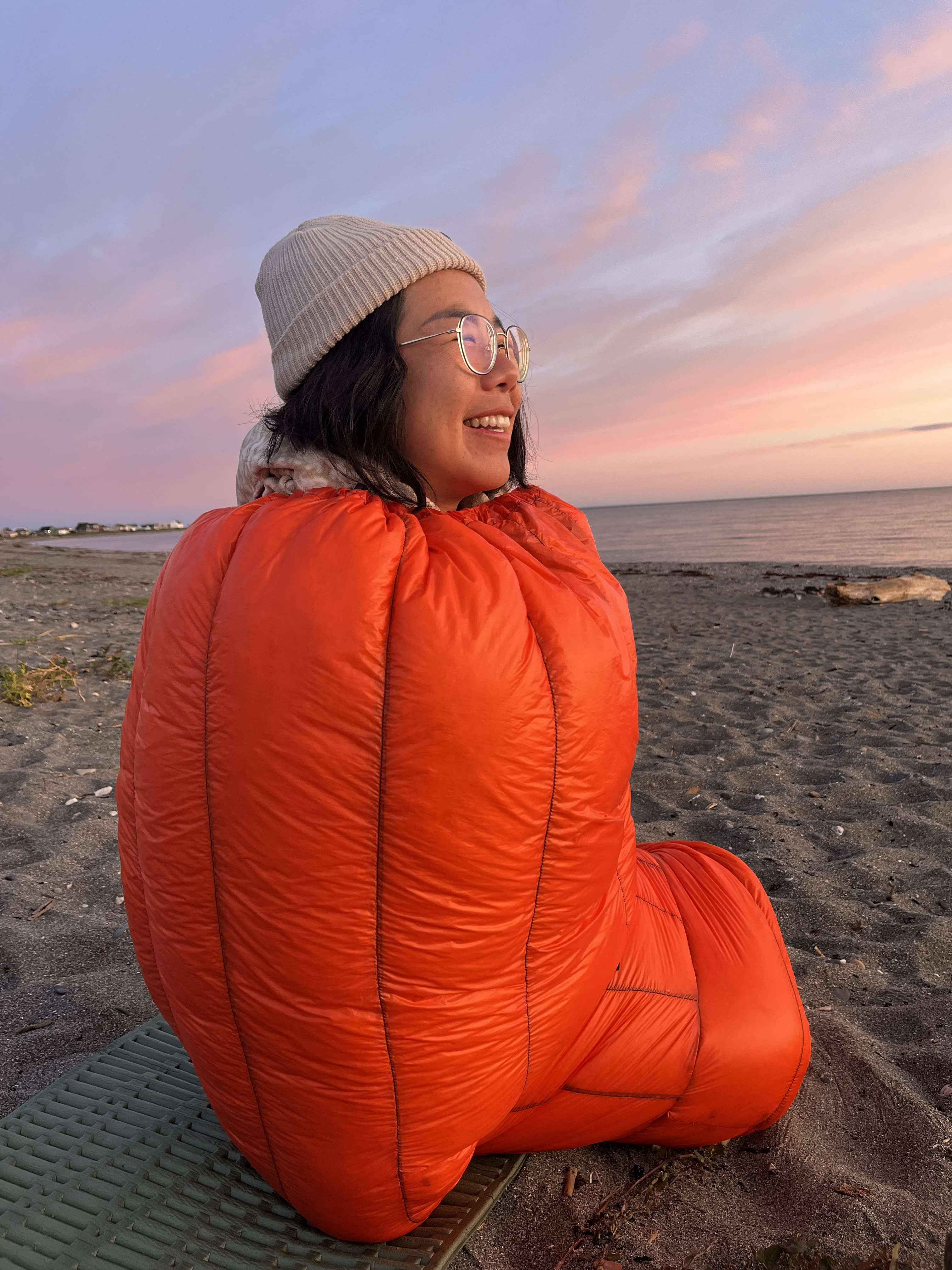 Détail d'un sac de couchage montrant la migration des plumes à l'intérieur, soulignant l'importance de la gestion et de l'entretien pour maintenir la performance.